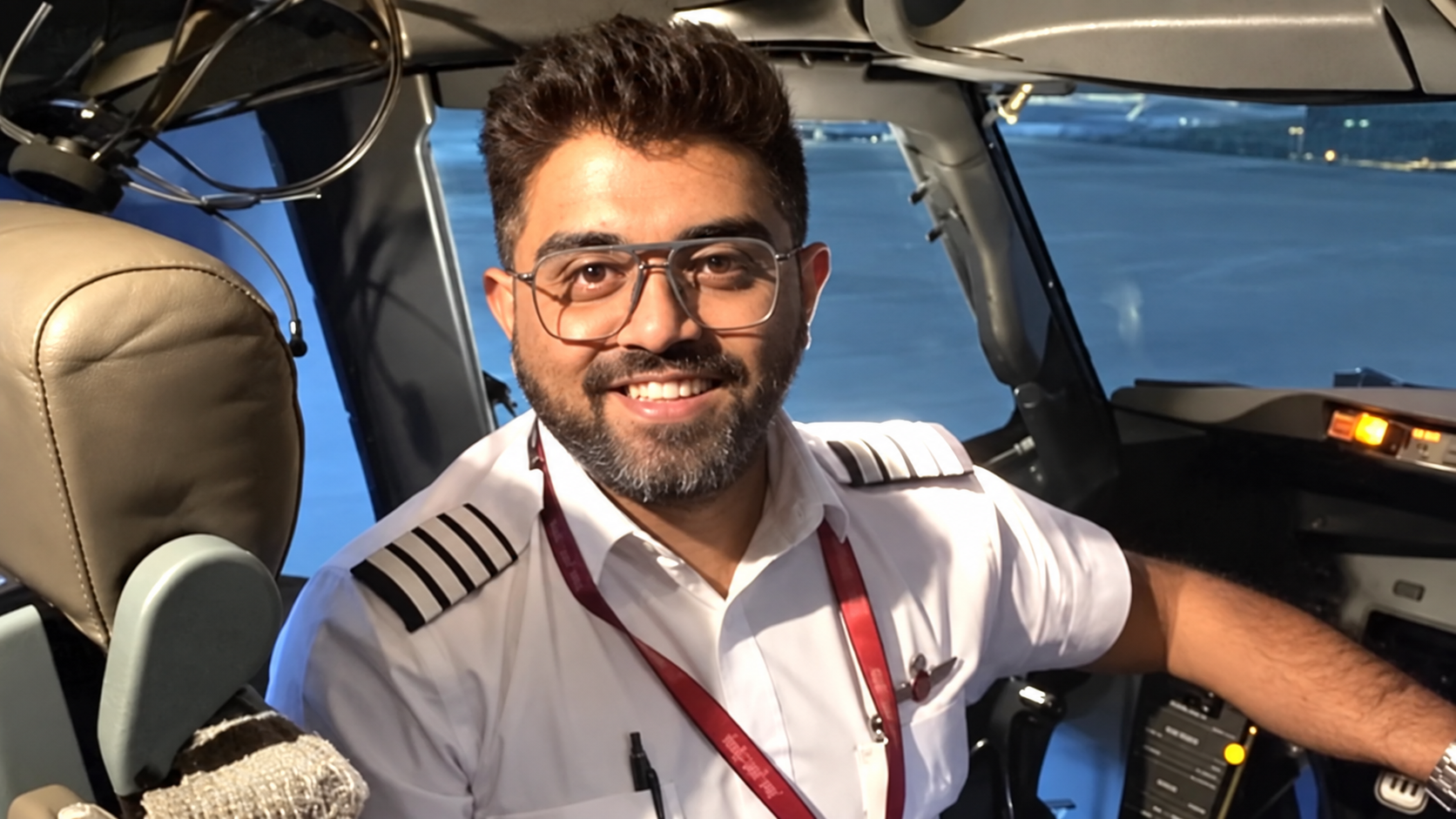 Smiling Pilot in a Nighttime Cockpit.png