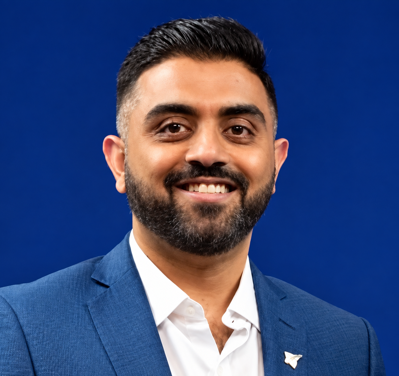 Warmly Smiling Man in Blue Blazer.png
